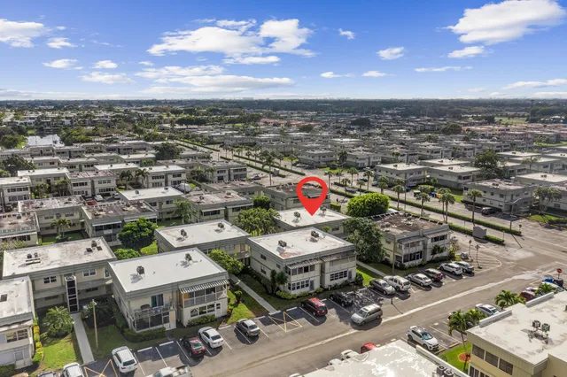 an aerial view of a pool patio chairs and fire pit