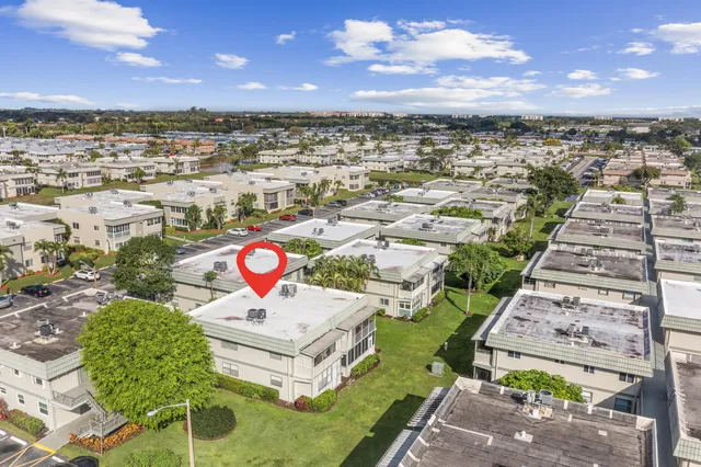 an aerial view of a house with a garden and lake view