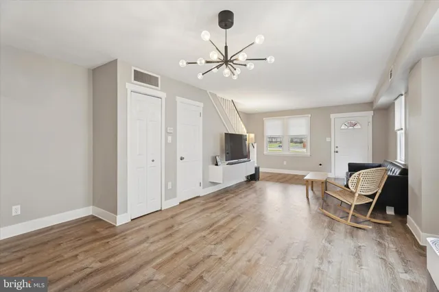 a living room with furniture and a chandelier