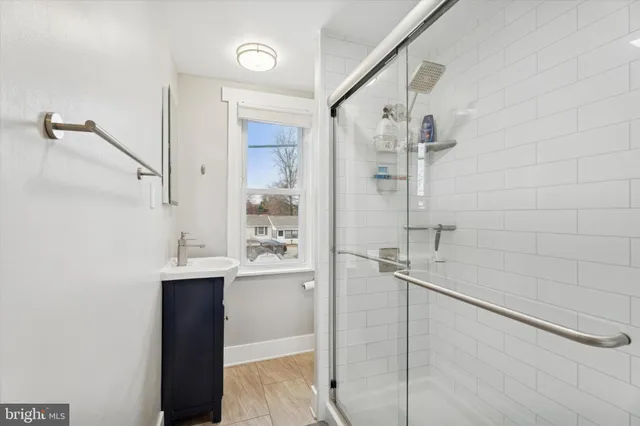 a bathroom with a shower and sink