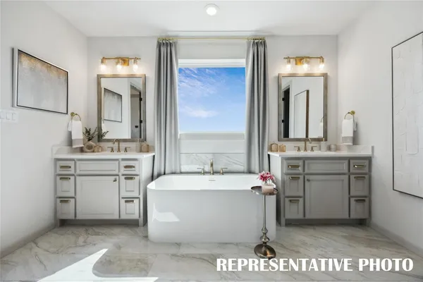 a en suite bathroom with a double sink shower and a mirror
