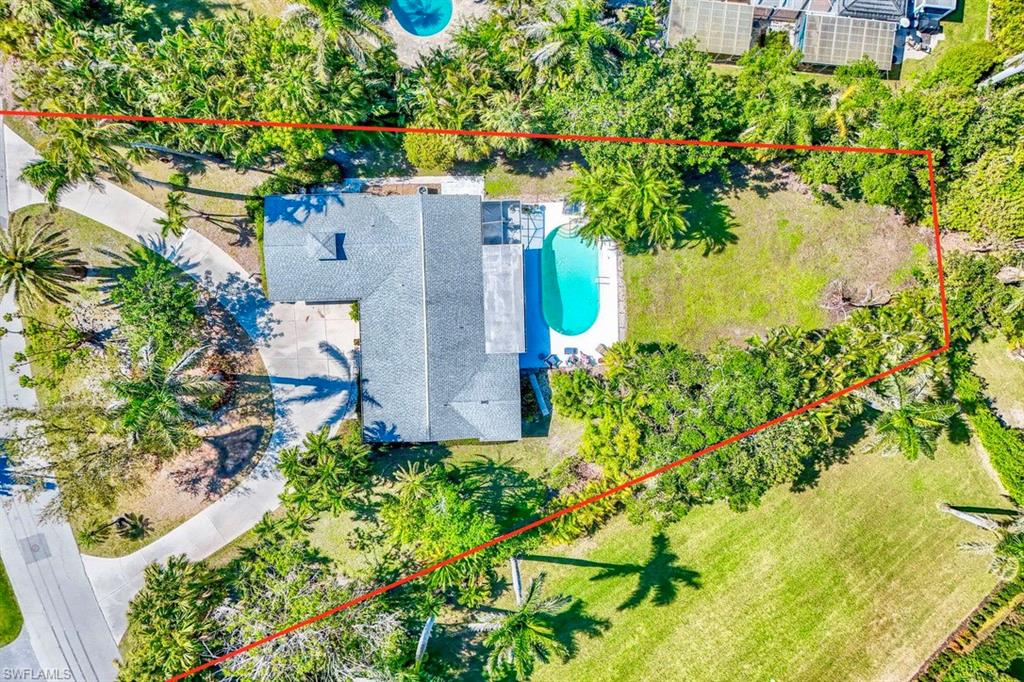 289 Springline Drive Naples, FL 34102 - Photo 2 of 9 an aerial view of a house with a yard lake and outdoor seating