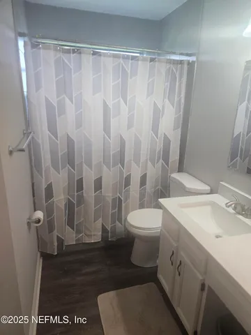 a white toilet sitting next to a bathroom sink