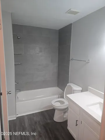 a white toilet sitting next to a bath tub