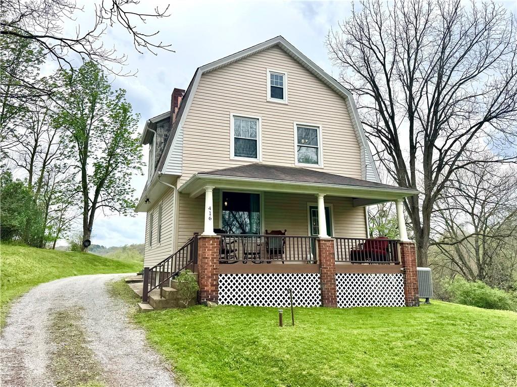 416 Pine Run Road Fombell, PA 16123 - Photo 1 of 50 a front view of a house with garden