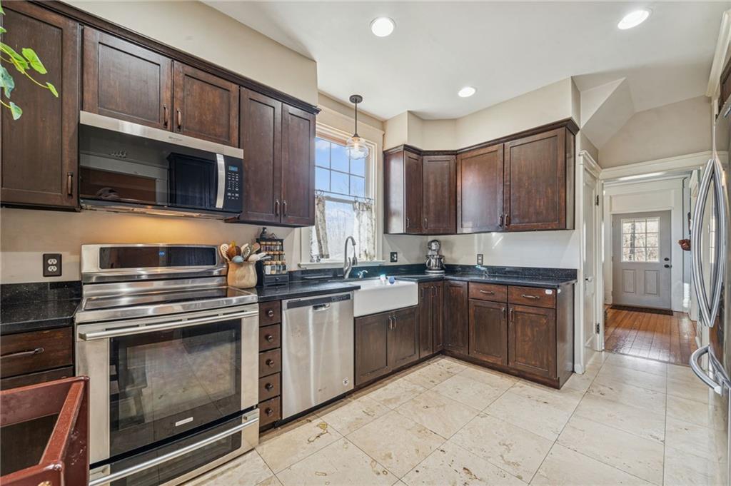 416 Pine Run Road Fombell, PA 16123 - Photo 12 of 50 a kitchen with stainless steel appliances granite countertop a stove microwave and cabinets