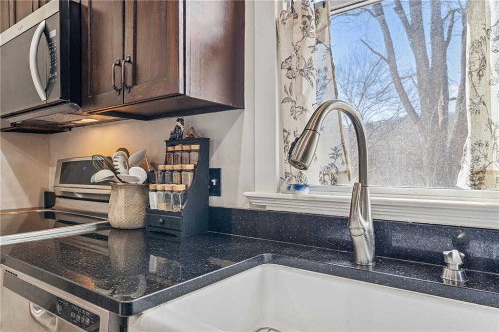 416 Pine Run Road Fombell, PA 16123 - Photo 14 of 50 a kitchen with a sink a counter and cabinets