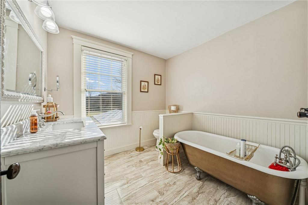416 Pine Run Road Fombell, PA 16123 - Photo 33 of 50 a bathroom with a tub sink and window