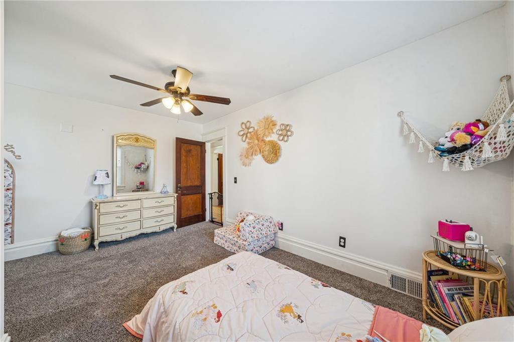 416 Pine Run Road Fombell, PA 16123 - Photo 36 of 50 a bedroom with a bed and a chandelier
