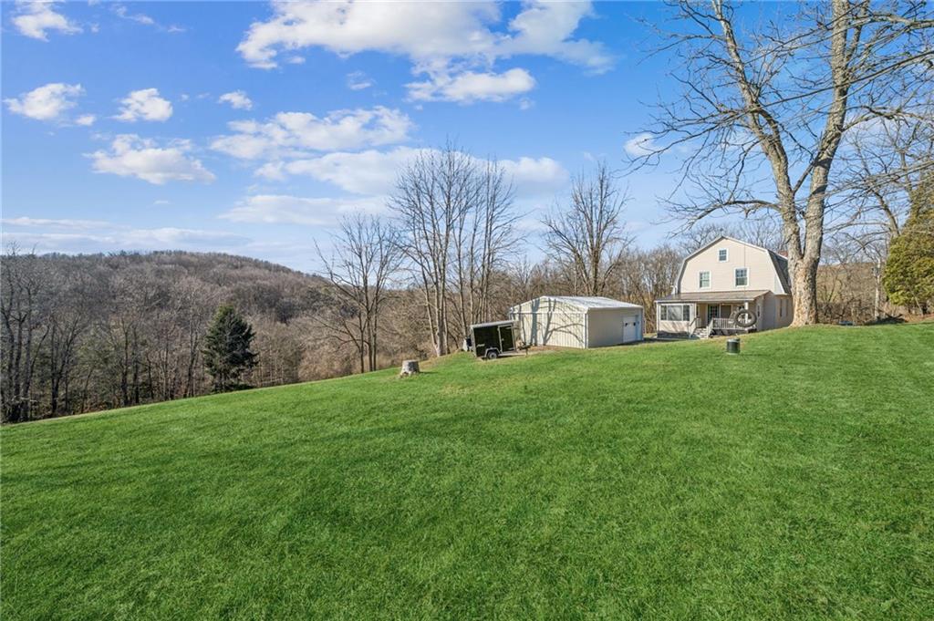 416 Pine Run Road Fombell, PA 16123 - Photo 43 of 50 a front view of a house with garden