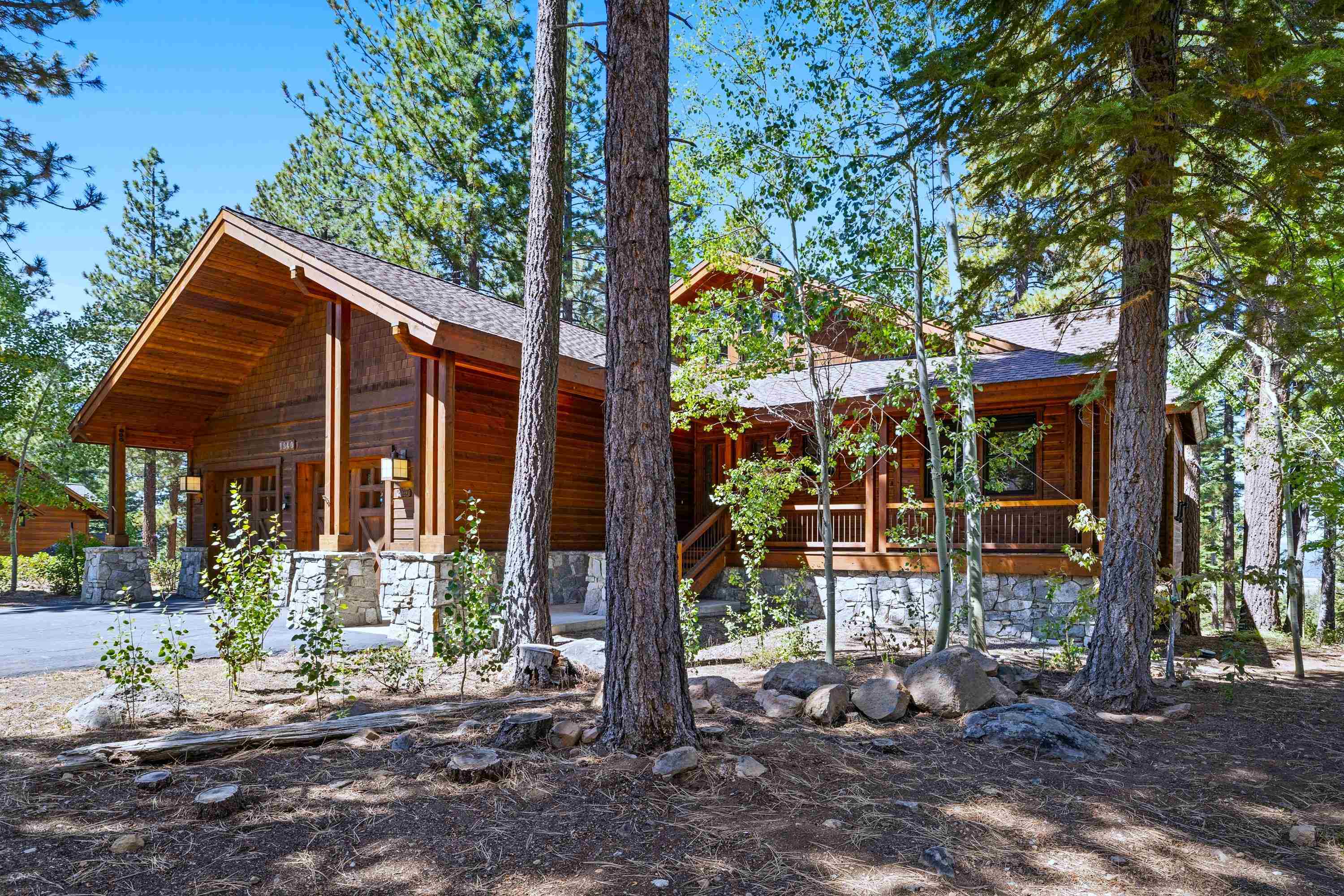 a view of a house with a tree in front of it