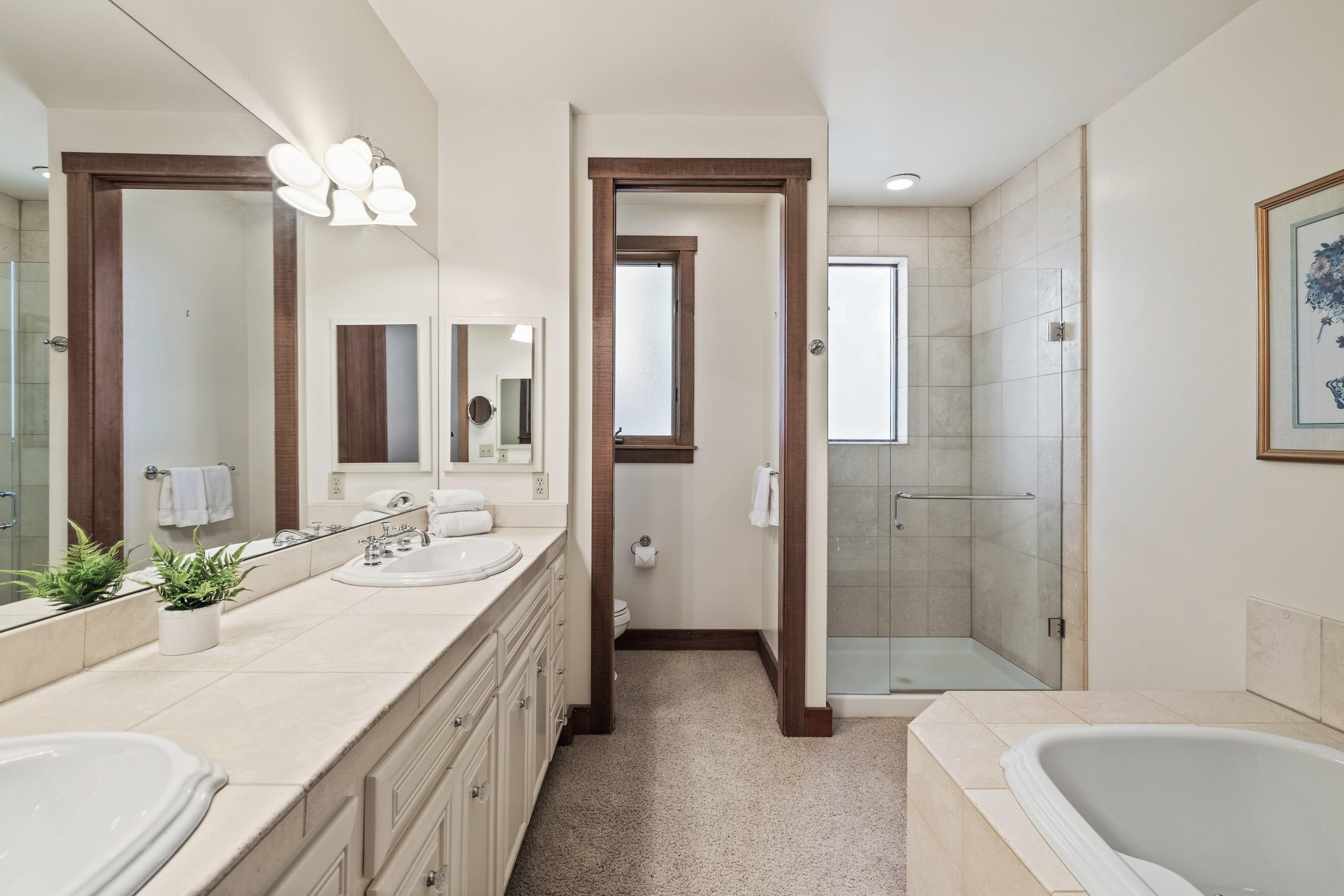 1940 Gray Wolf Truckee, CA 96161 - Photo 11 of 20 a spacious bathroom with a double vanity sink a large mirror and a bathtub