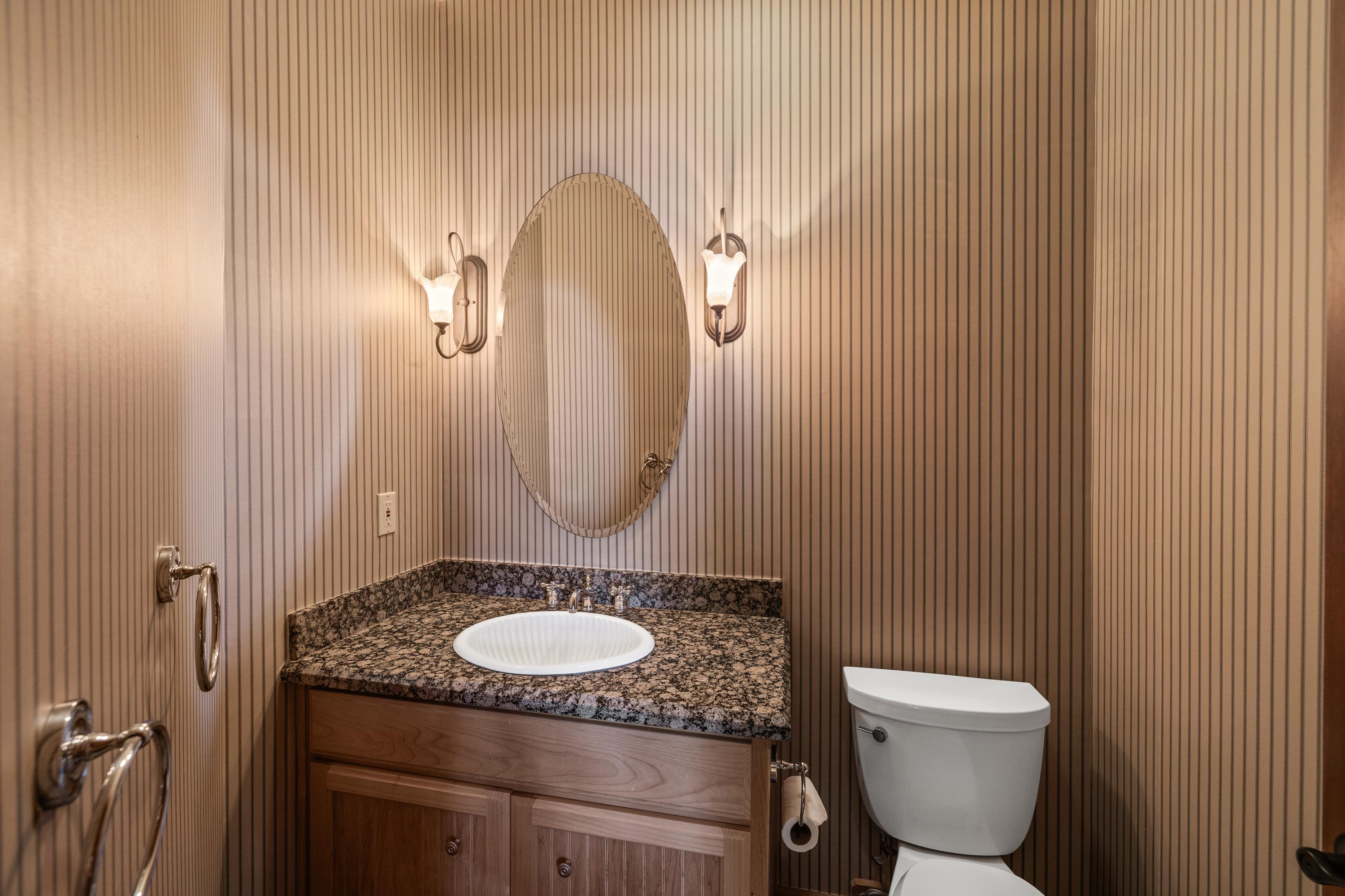 1940 Gray Wolf Truckee, CA 96161 - Photo 15 of 20 a bathroom with a granite countertop toilet sink and mirror