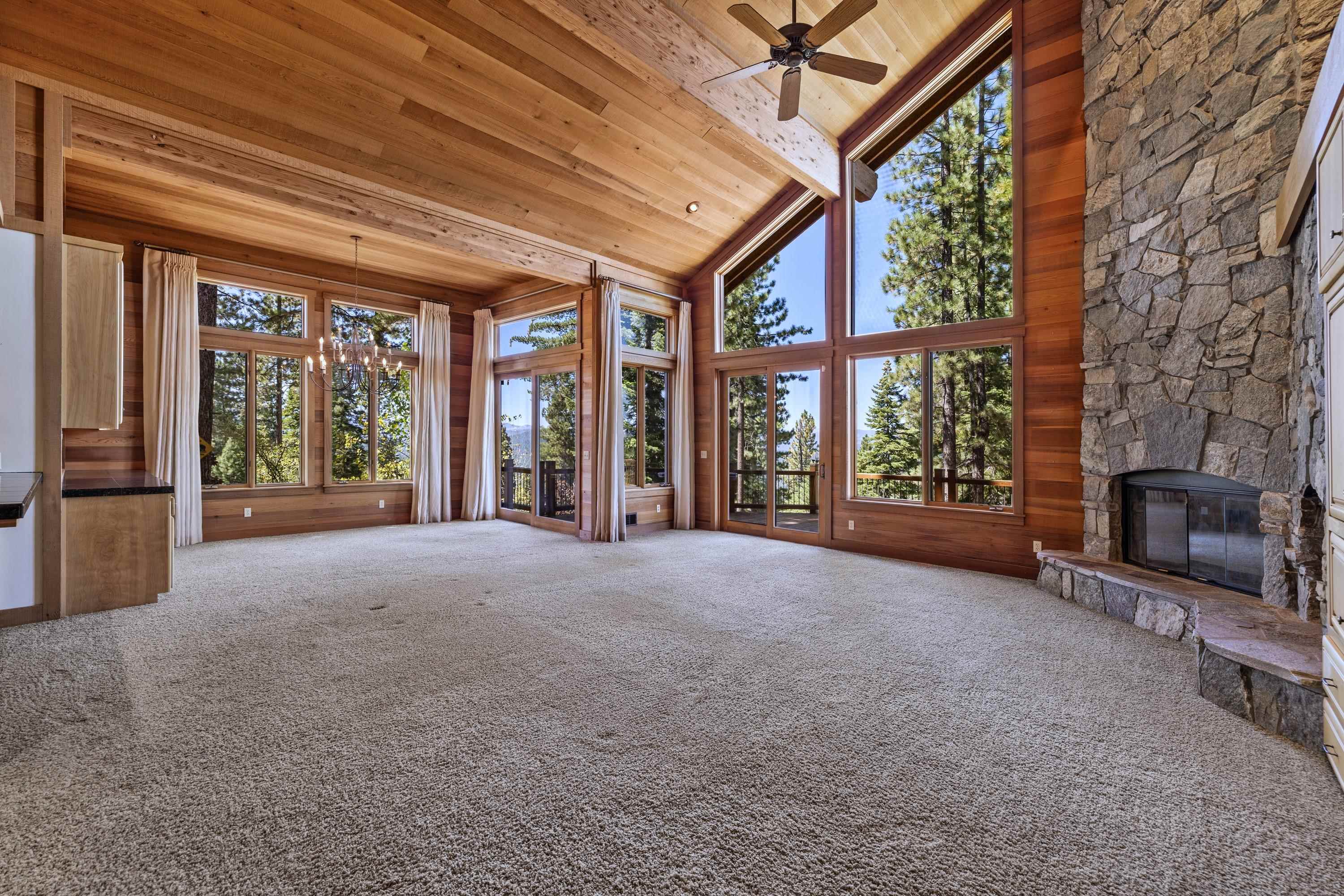 1940 Gray Wolf Truckee, CA 96161 - Photo 5 of 20 a view of an empty room with a fireplace and large windows