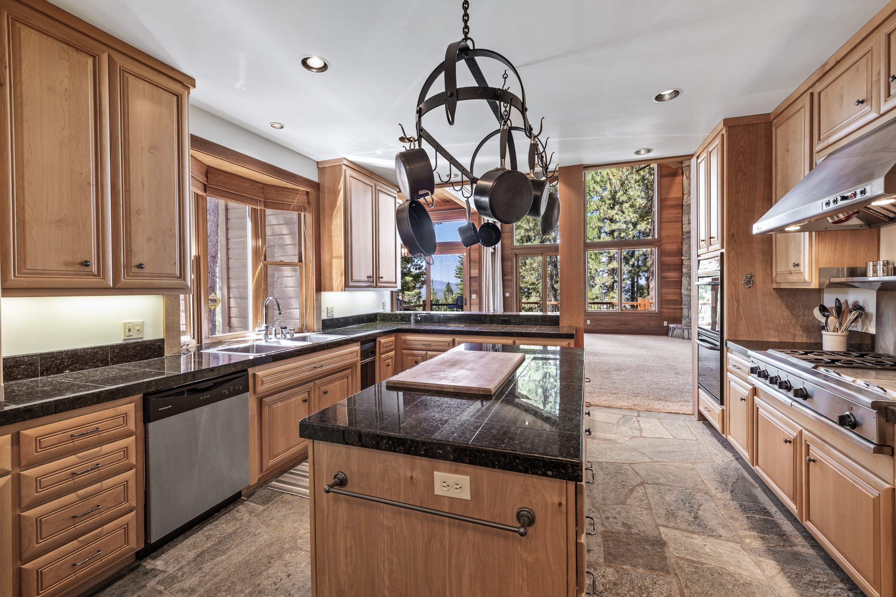 1940 Gray Wolf Truckee, CA 96161 - Photo 8 of 20 a kitchen with stainless steel appliances granite countertop a stove and cabinets