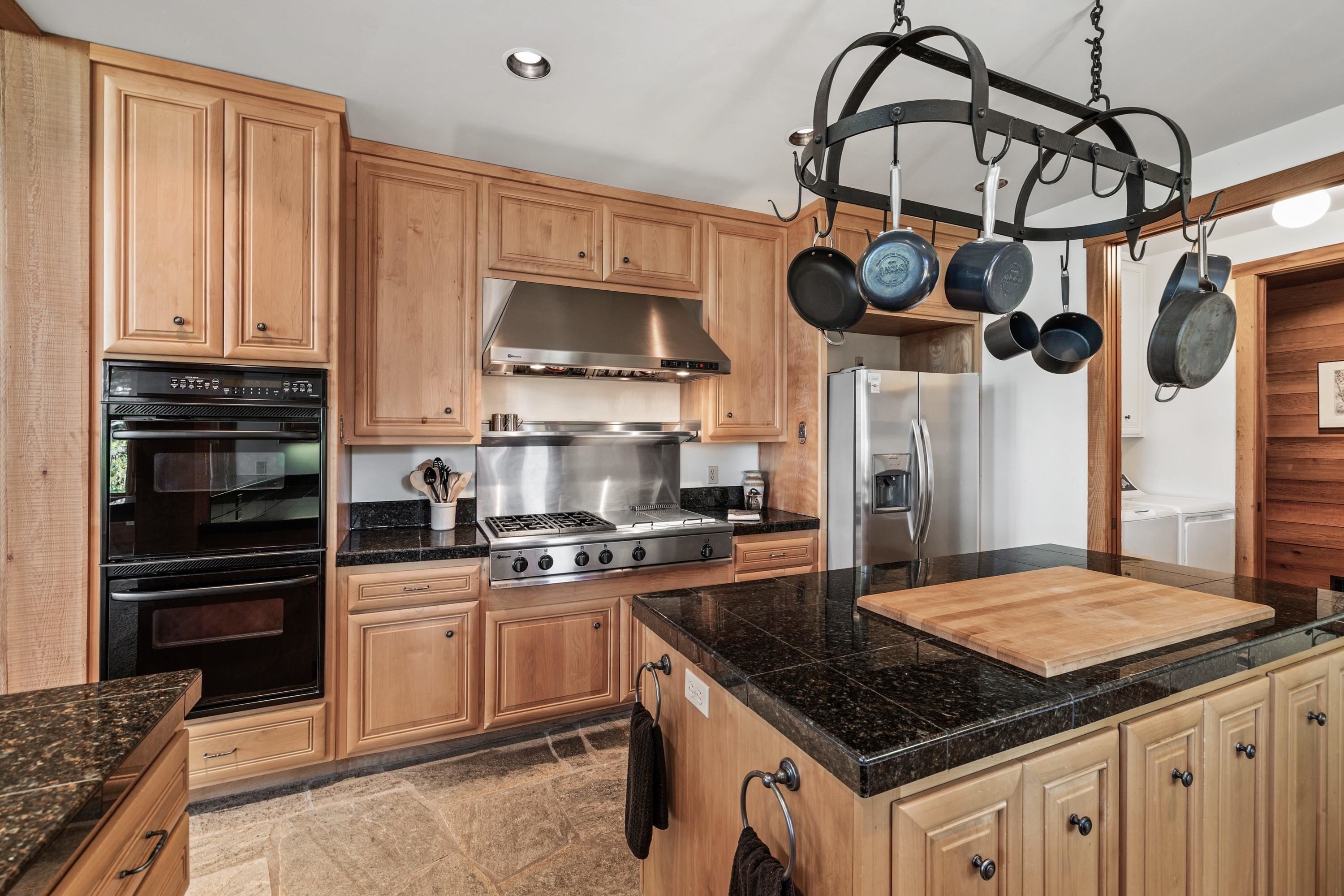 1940 Gray Wolf Truckee, CA 96161 - Photo 9 of 20 a kitchen with stainless steel appliances granite countertop a sink a stove and a wooden cabinets