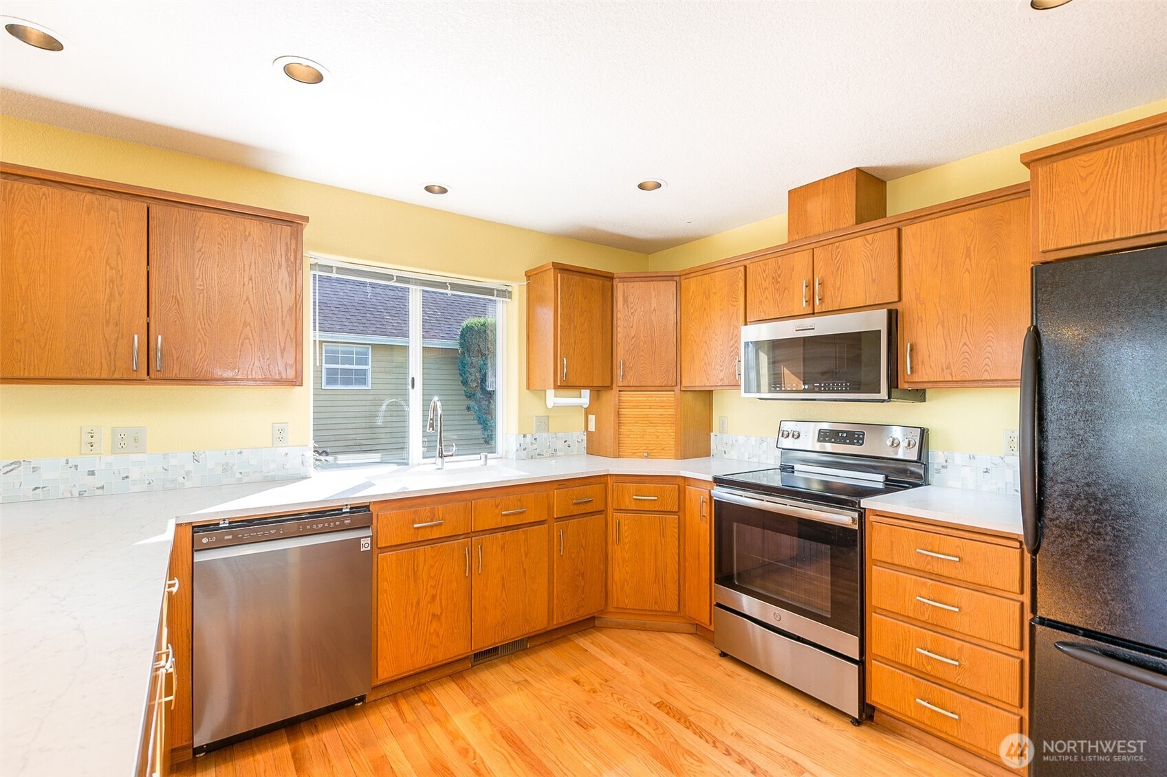 170 Hurricane Ridge Drive Sequim, WA 98382 - Photo 20 of 39 a kitchen with stainless steel appliances granite countertop a sink and cabinets
