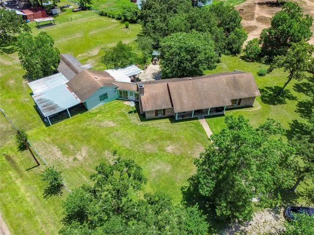 an aerial view of a house with yard and outdoor seating