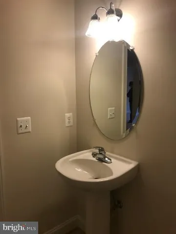 a bathroom with a sink and mirror