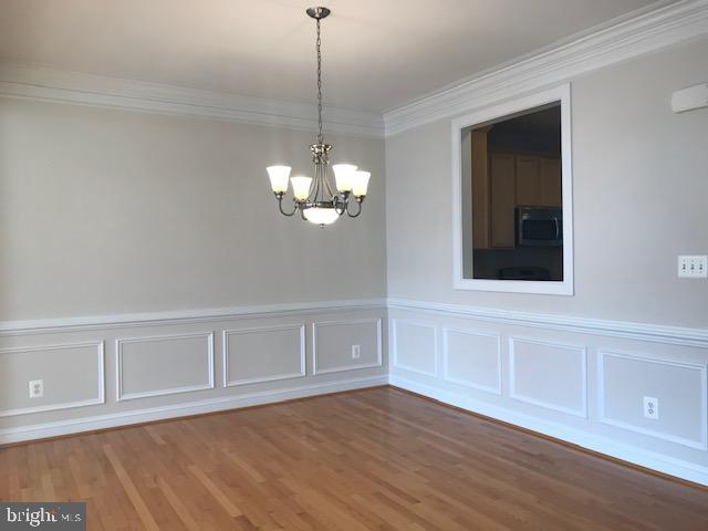 3680 Chippendale Circle Woodbridge, VA 22193 - Photo 19 of 49 a view of an empty room with chandelier fan and wooden floor