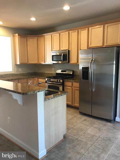 3680 Chippendale Circle Woodbridge, VA 22193 - Photo 23 of 49 a kitchen with stainless steel appliances granite countertop a refrigerator oven a sink a stove and a window