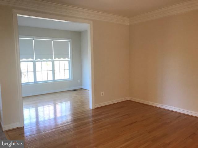 3680 Chippendale Circle Woodbridge, VA 22193 - Photo 27 of 49 a view of an empty room with wooden floor and a window