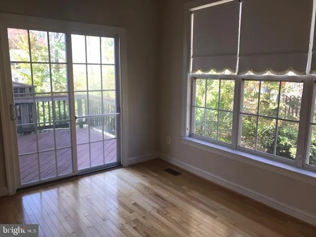 a view of a room window and wooden floor