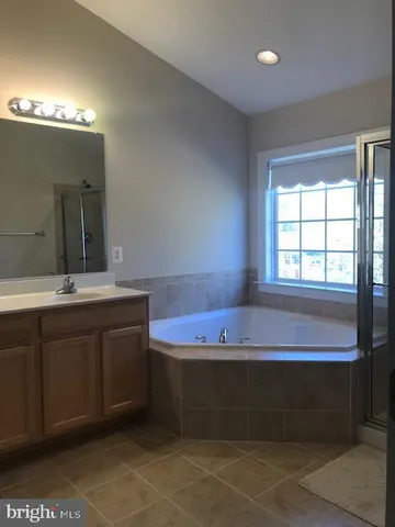 a bathroom with a bathtub and a sink