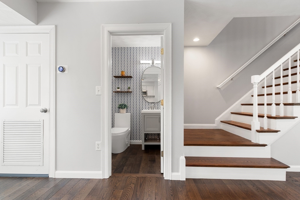 2 Ricciuti Drive, Unit 9 Quincy, MA 02169 - Photo 13 of 40 a view of entryway and hall with wooden floor