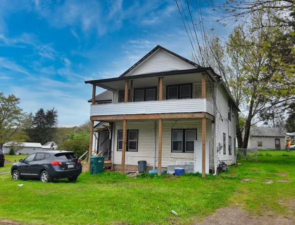a front view of a house with a yard
