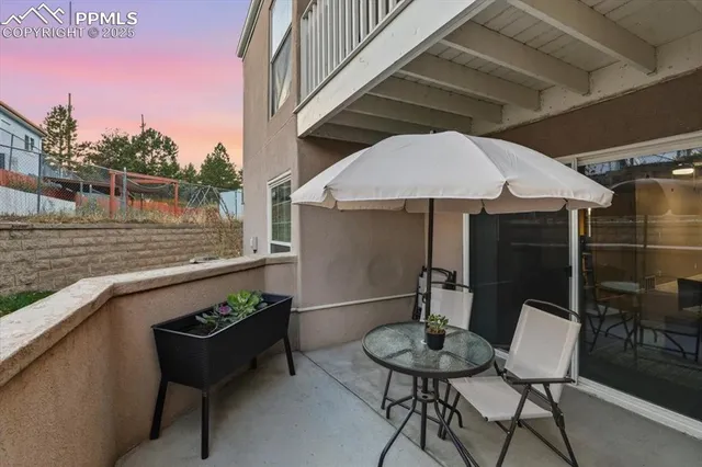 a backyard of a house with table and chairs