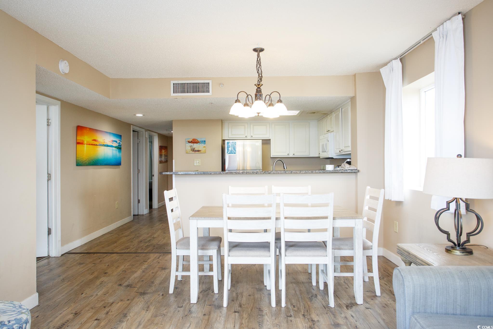 201 74th Avenue North, Unit 1401 Myrtle Beach, SC 29572 - Photo 12 of 32 Dining space featuring light wood-type flooring an