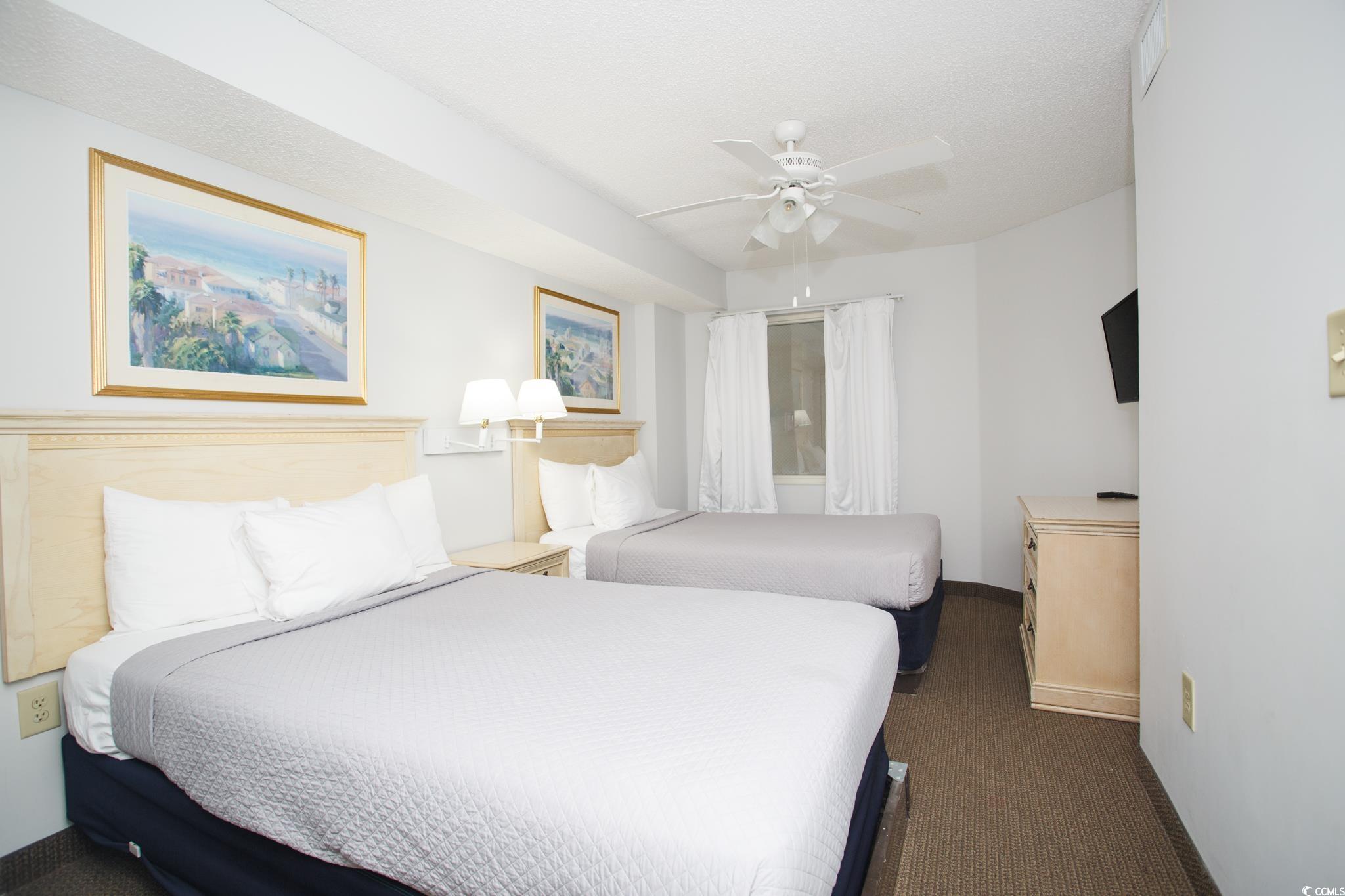 201 74th Avenue North, Unit 1401 Myrtle Beach, SC 29572 - Photo 19 of 32 Bedroom with ceiling fan, carpet flooring, and a t