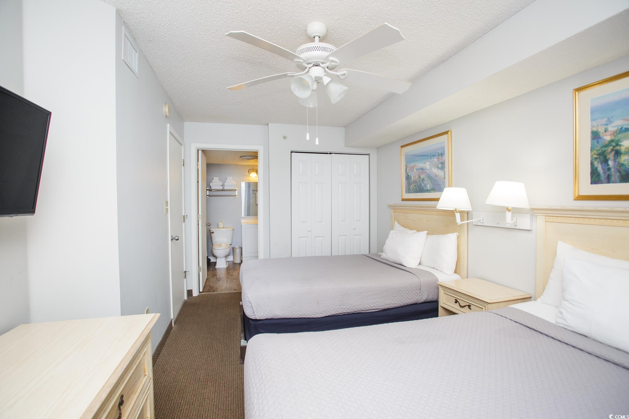 201 74th Avenue North, Unit 1401 Myrtle Beach, SC 29572 - Photo 20 of 32 Bedroom featuring a textured ceiling, a closet, ce