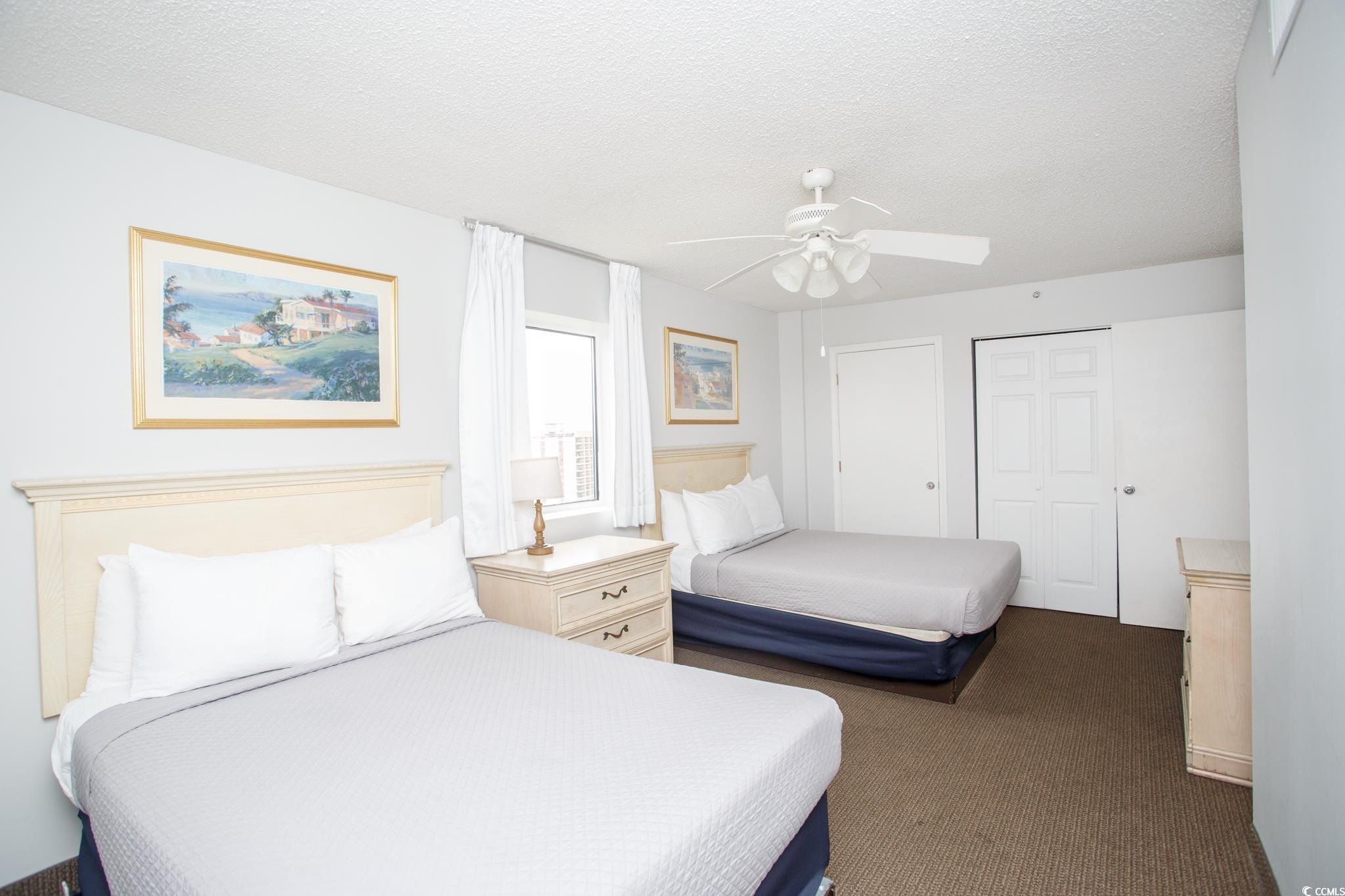 201 74th Avenue North, Unit 1401 Myrtle Beach, SC 29572 - Photo 23 of 32 Bedroom featuring a textured ceiling, a closet, ca