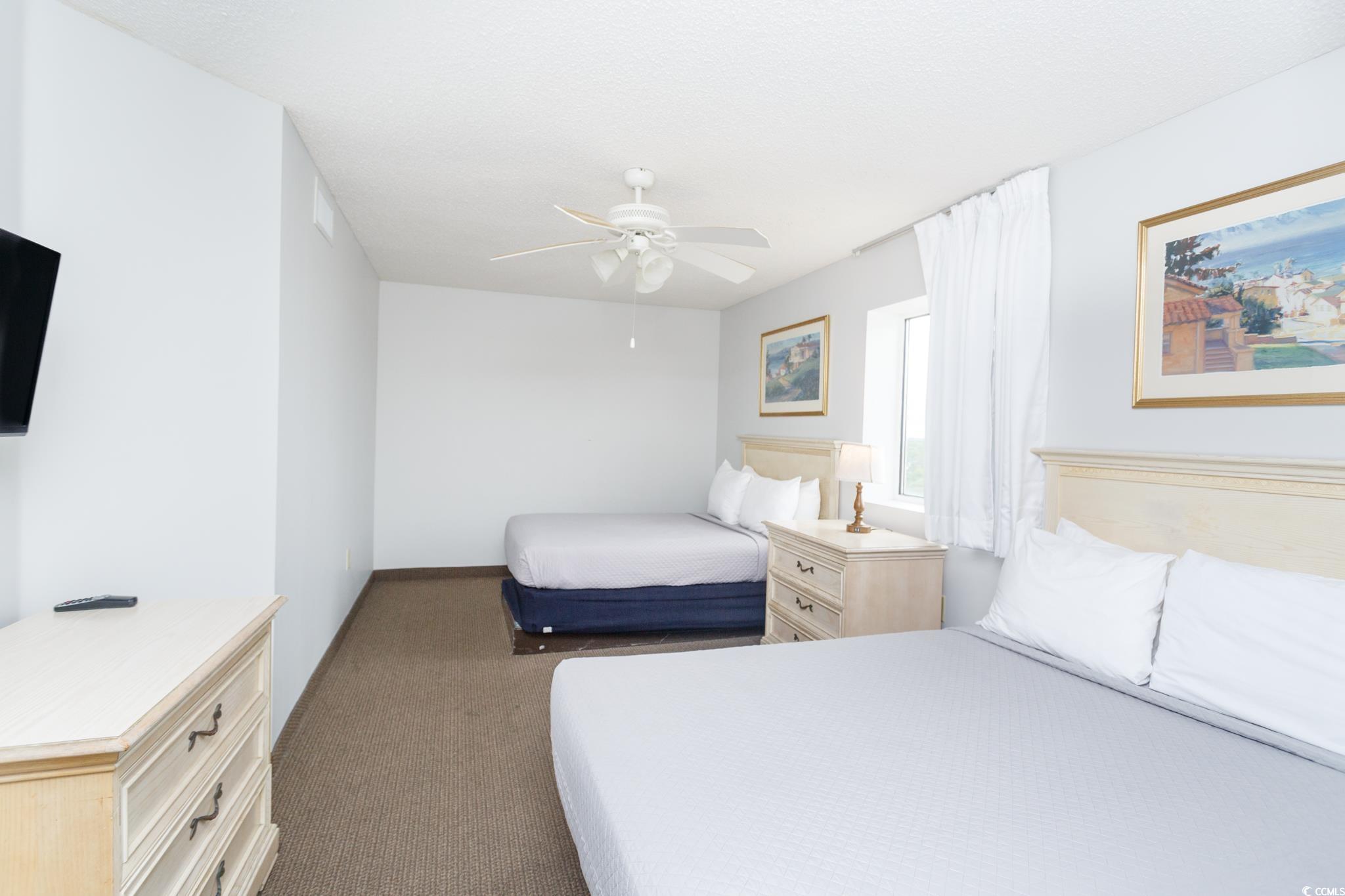 201 74th Avenue North, Unit 1401 Myrtle Beach, SC 29572 - Photo 24 of 32 Carpeted bedroom with baseboards and ceiling fan