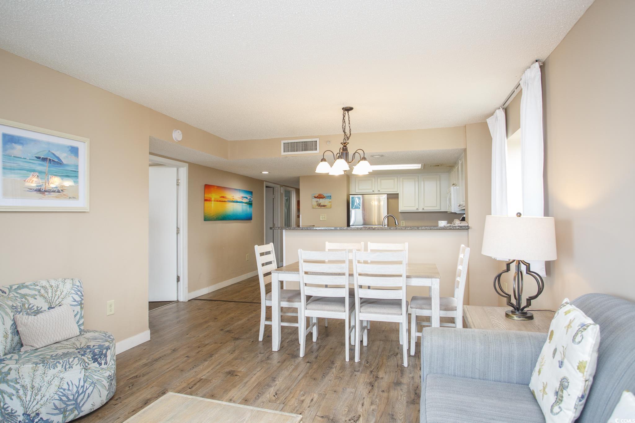 201 74th Avenue North, Unit 1401 Myrtle Beach, SC 29572 - Photo 10 of 32 Dining room featuring light wood finished floors a