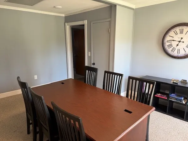 a view of a dining room with furniture and a table