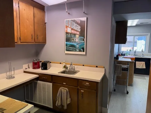 a kitchen with a sink stove and cabinets