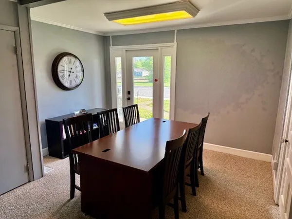 a view of a dining room with furniture and a large window