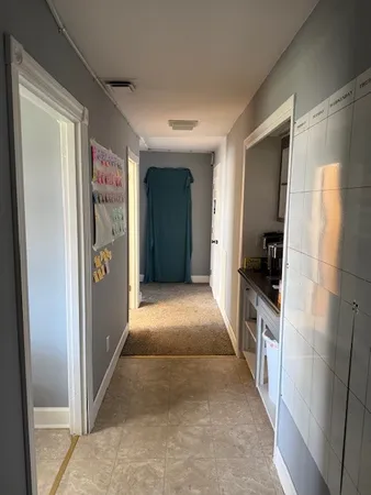 a view of hallway with stairs and wooden floor