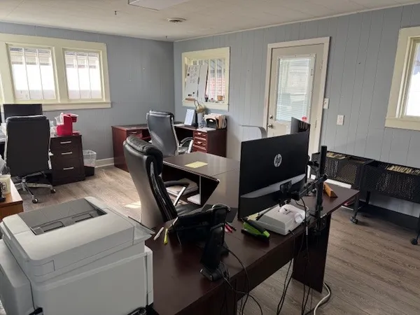 a view of a workspace with furniture and window in it