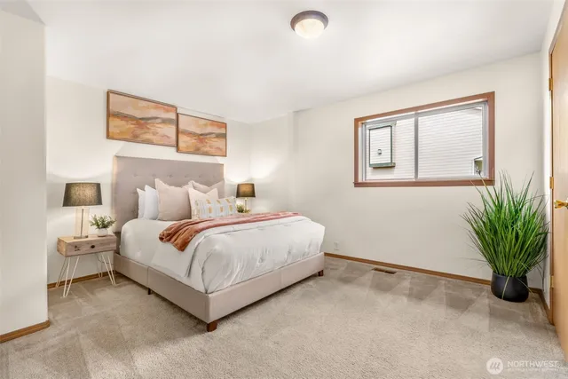 a bedroom with a bed and a potted plant