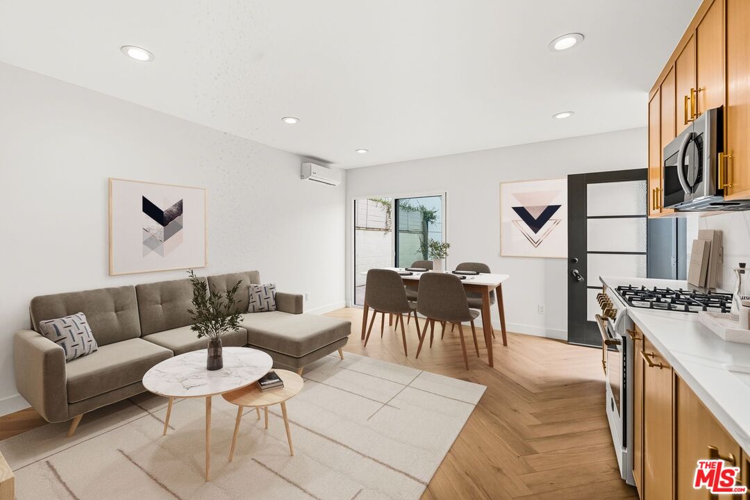 6327 Babcock Avenue Valley Glen, CA 91606 - Photo 11 of 21 a living room with furniture a fireplace and a kitchen view