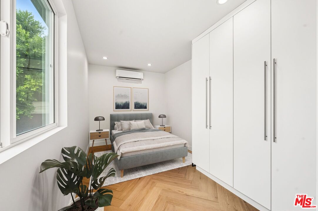 6327 Babcock Avenue Valley Glen, CA 91606 - Photo 12 of 21 a bedroom with a bed table flowerpot and window