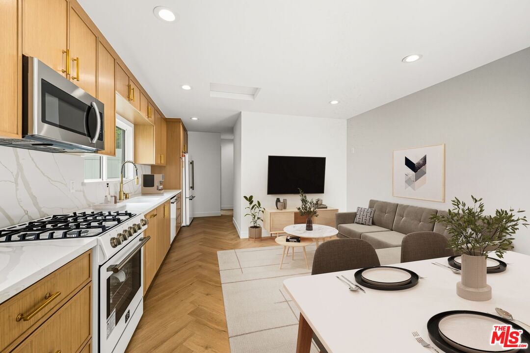 6327 Babcock Avenue Valley Glen, CA 91606 - Photo 8 of 21 a living room with furniture a flat screen tv and a dining table