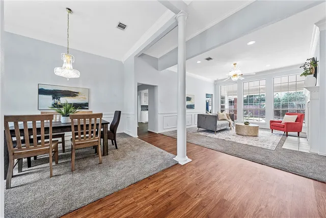 a dining room with furniture and wooden floor