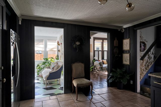 a living room with furniture and a floor to ceiling window