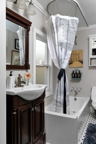 a bathroom with a sink a mirror and bathtub