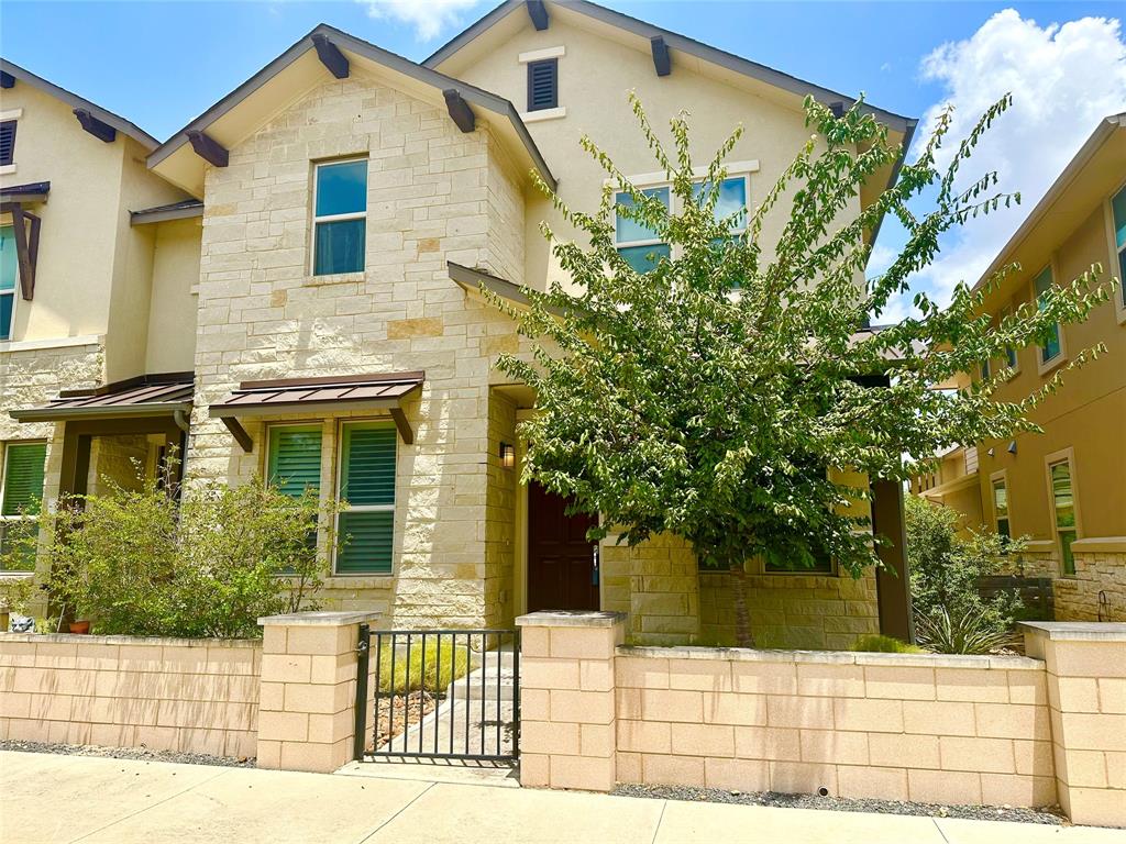 6814 East Riverside Drive, Unit 26 Austin, TX 78741 - Photo 19 of 21 A charming facade boasts a mix of stone and stucco, featuring an inviting entrance with a metal gate.